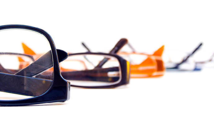 glasses layed on a white surface with white background